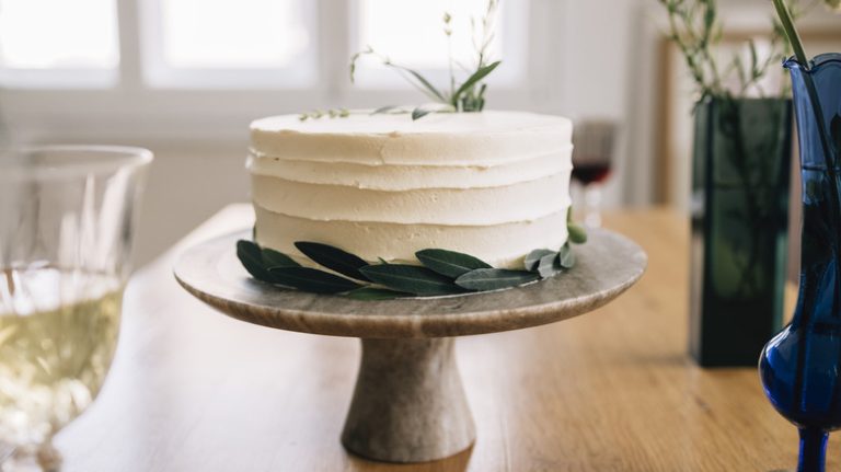 decorated cake on pedestal