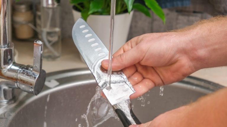 Person washing a knife