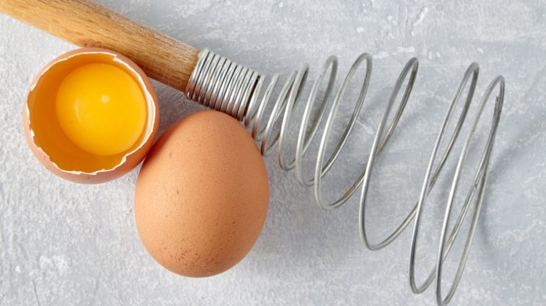 Spring coil whisk and cracked egg